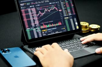 small laptop that is dark showing a trading chart
