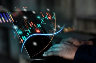 hand typing on laptop showing trading chart