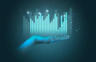 Hand holding light blue virtual trading chart