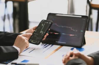 phone and tablet with hand showing forex chart
