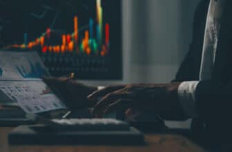 side picture of hands and trading chart