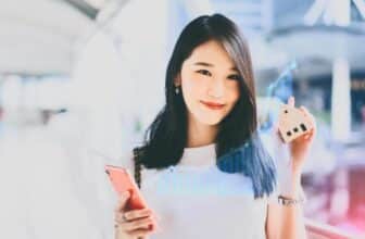 woman holding phone with virtual forex chart overaly