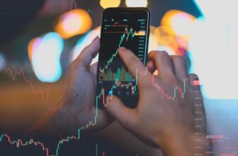 phone and hand with forex chart on phone