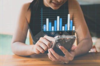 woman holding phone with virtual trading chart