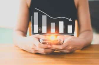 woman holding phone with 2 hands showing forex chart going down