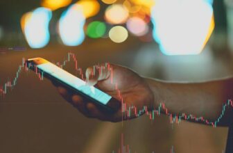 hand holding phone with forex chart overlay